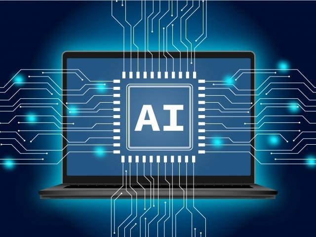 Laptop displaying a central AI chip with glowing circuits radiating outward, symbolizing artificial intelligence in computing.