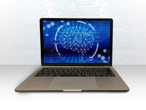 Laptop on a white surface displaying a blue AI brain graphic on the screen.