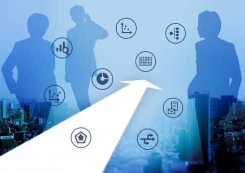 Three silhouetted businesspeople overlook a cityscape as a white arrow points forward, surrounded by circular icons for data, charts, and communication, suggesting forward momentum and strategy.